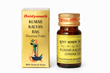 Baidyanath Kumar Kalyan Ras (Swarma Yukt) golden outer packaging box and matching amber glass medicine bottle with a golden cap, yellow label featuring product details in English and Hindi, a laboratory scientific illustration, and "With Gold & Pearl" text | BodyStop