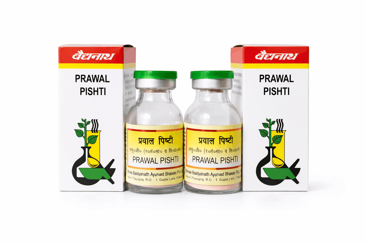 Two pairs of 10 Gm Baidyanath Prawal Pishti glass medicine bottles with green caps and yellow labels, each placed next to its corresponding white and red outer packaging box featuring the brand logo and traditional mortar and pestle illustration | BodyStop