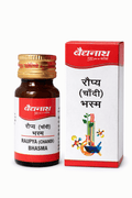 Baidyanath Raupya (Chandi) Bhasma 1 Gm and 2.5 Gm amber glass medicine bottle with a golden cap and white-and-red label next to its matching outer packaging box featuring the brand logo, product title in Hindi, and laboratory scientific illustration | BodyStop