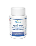 Dhootapapeshwar Amrutadi Guggul white plastic bottle with a white cap and product label featuring Hindi and English titles (अमृतादि गुग्गुल / AMRUTADI GUGGUL), regulatory reference (भावप्रकाश मध्यम खंड (वातरक्त) १७७-१८१), and category badge (गुग्गुलकल्प) | BodyStop