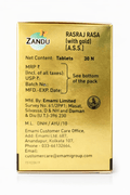 Zandu Rasraj Rasa with gold packaging side view displaying net content, manufacturing and marketing details by Emami Limited, license number, and customer care contact information | BodyStop